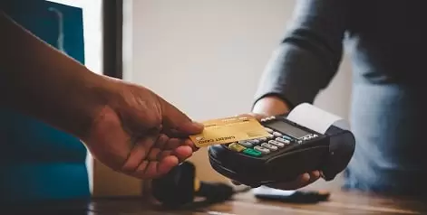 close up hand using credit card pay by sending credit card staff credit card swipe machine online payment